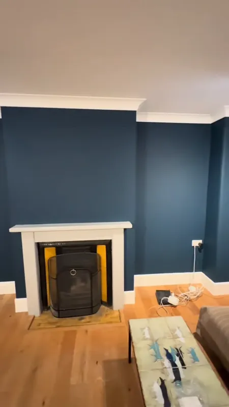 Living room walls painted deep blue-green in Rickmansworth