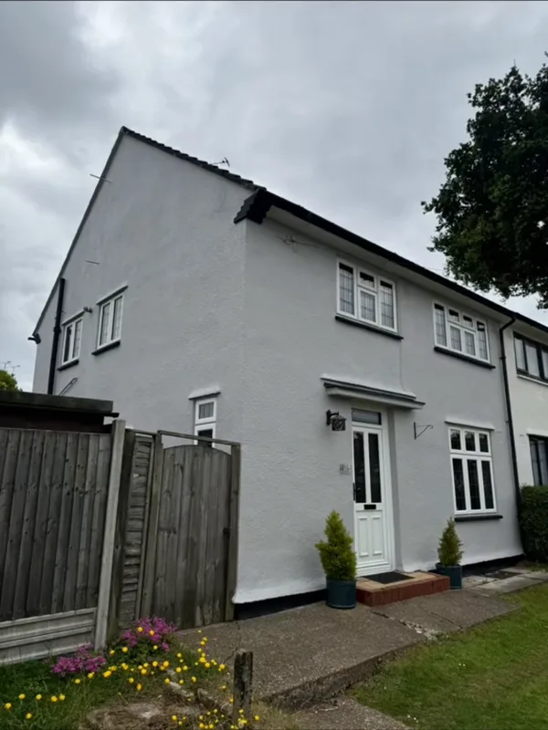 The side of the house, from the gate — after