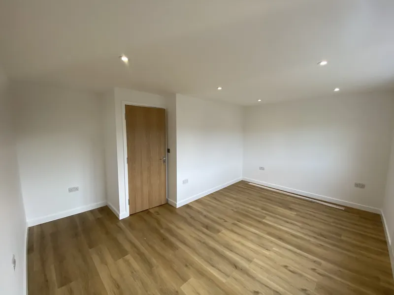 Loft bedroom with oak-effect door