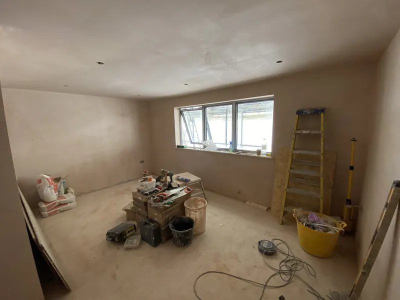 Loft bedroom: fresh plaster to painted, with skirtings, architraves and engineered wood flooring — during