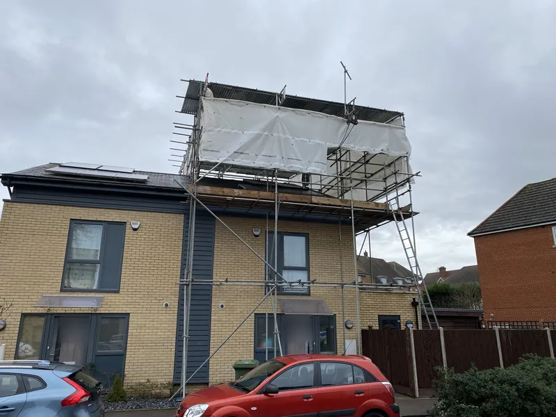 House scaffolded with a temporary roof