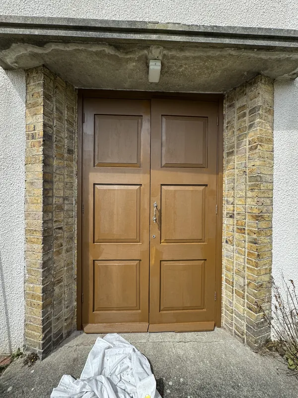 The front doors: sanded and filled, then given a rich new finish — after