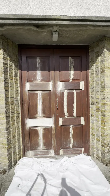 The front doors: sanded and filled, then given a rich new finish — before