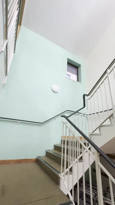 The staircase: walls and ceiling repainted, green feature wall refreshed — before