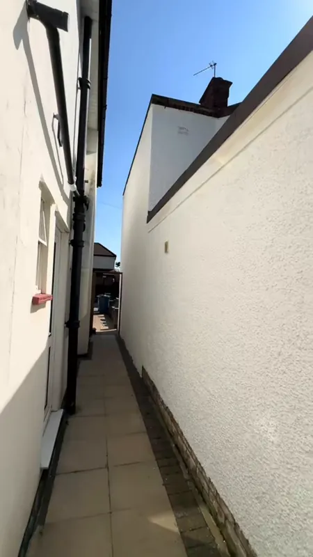The side passage, from grey render to brilliant white — after