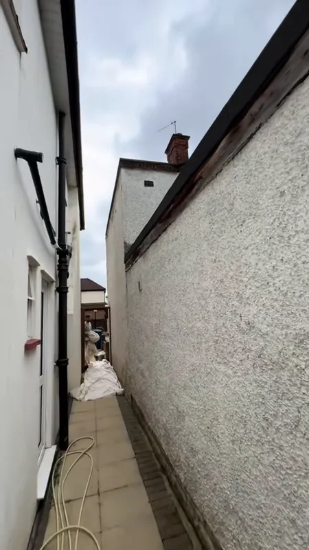 The side passage, from grey render to brilliant white — before
