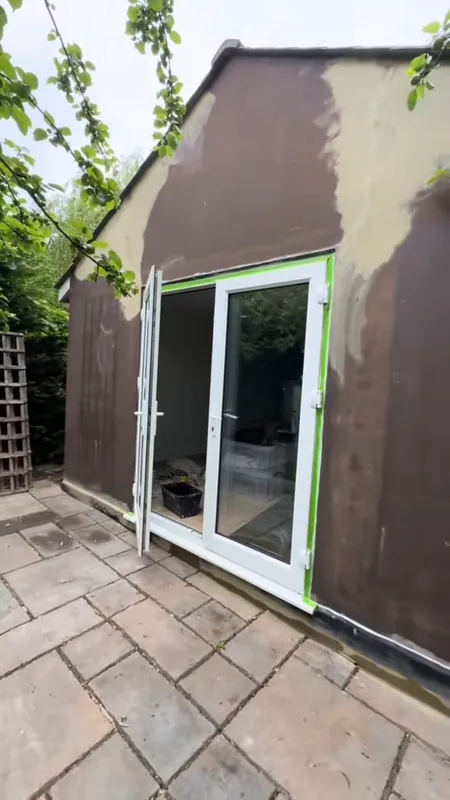 The cracks in the gable end filled, with the door frames masked off