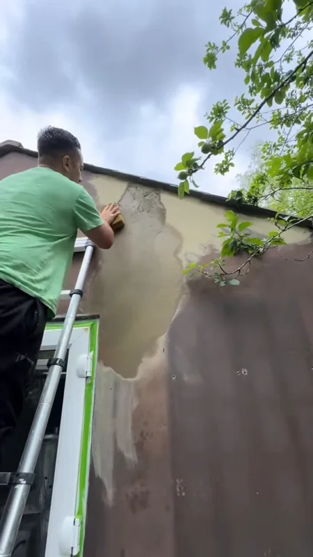 Filling the cracks high up on the gable