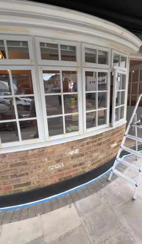 The shopfront windows primed and painted