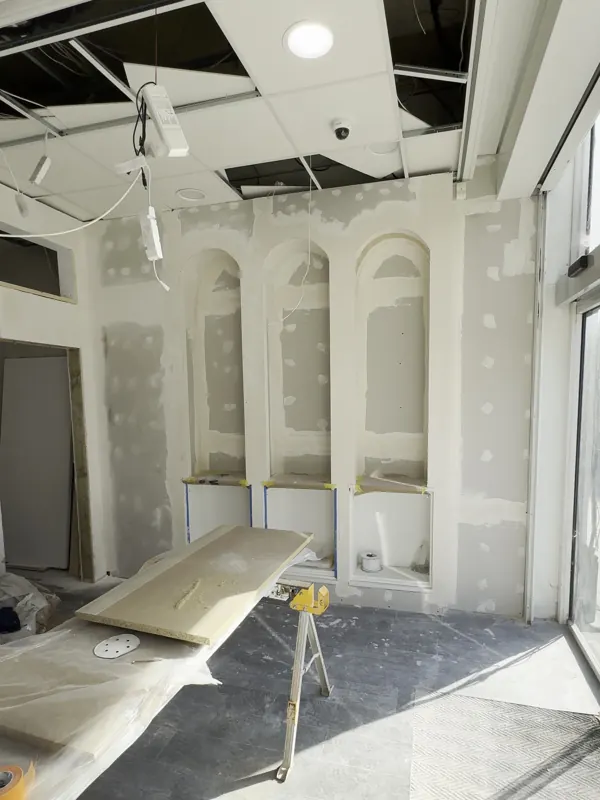Reception: arched display niches built, then finished and lit — during