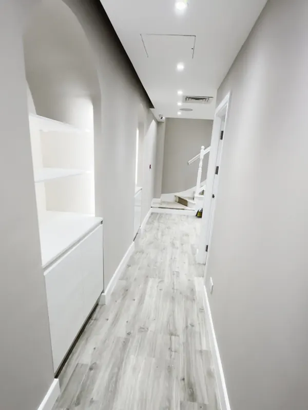 Corridor: dark built-in cupboards replaced with arched shelving — after