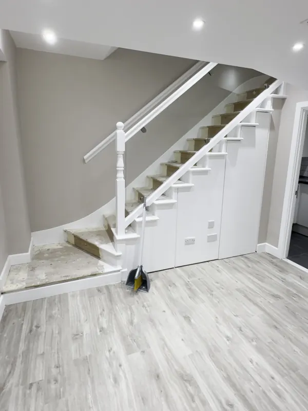Stair hall: tiles replaced with wood-effect flooring and the walls repainted — after