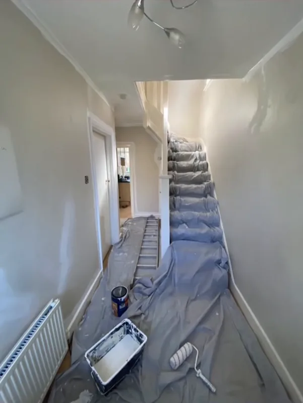 The hallway sheeted, with the painting under way