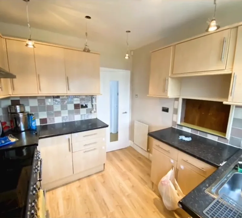The kitchen, covered up for painting, then finished — after