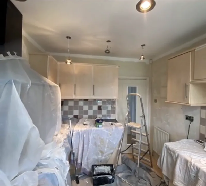 The kitchen, covered up for painting, then finished — during