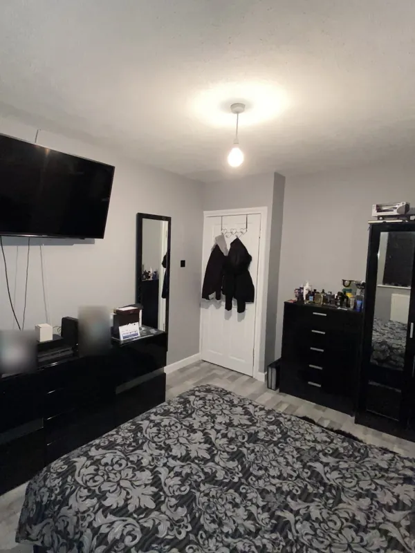 The same view from the bed: stripped, replastered and redecorated — after