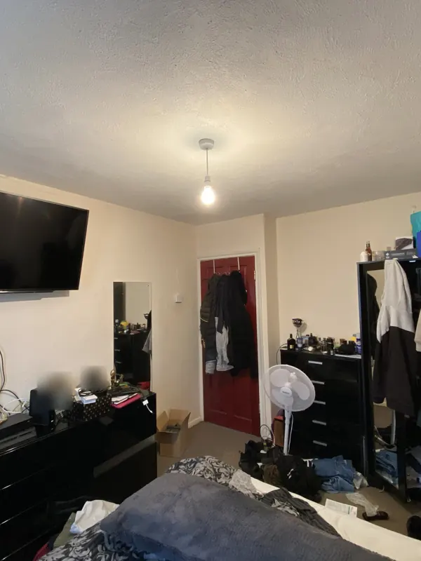 The same view from the bed: stripped, replastered and redecorated — before