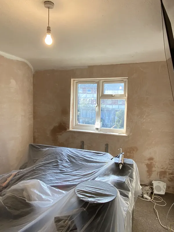 Window wall: fresh plaster to finished grey walls — during