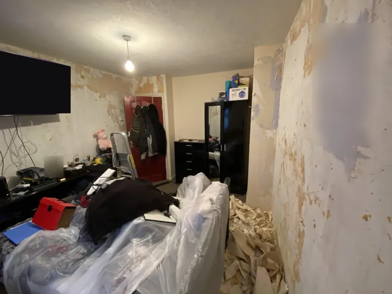 Old wallpaper stripped back