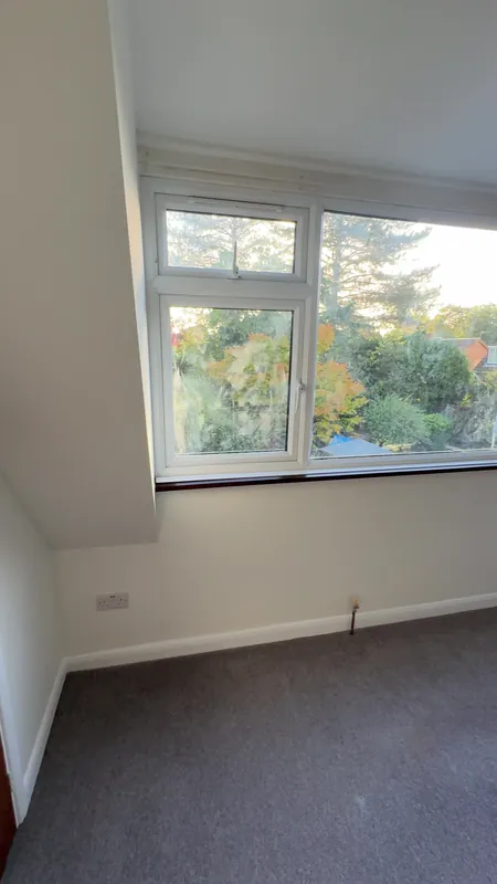The same bedroom, window wall — after