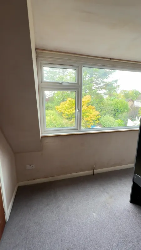 The same bedroom, window wall — before