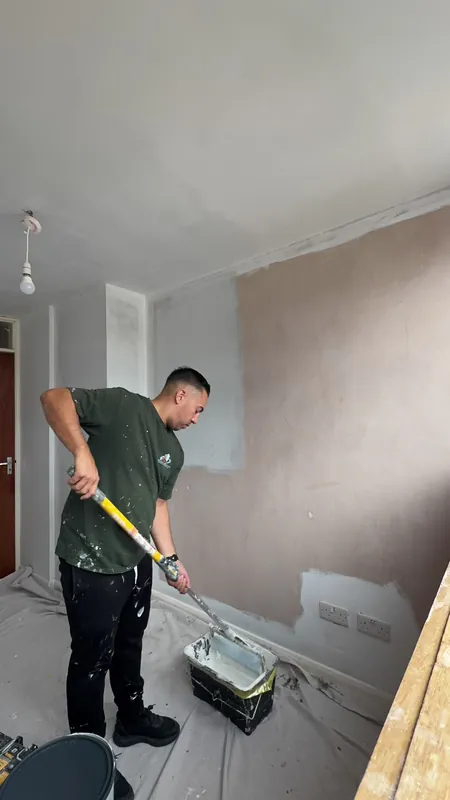 Rolling on the mist coat to seal the plaster