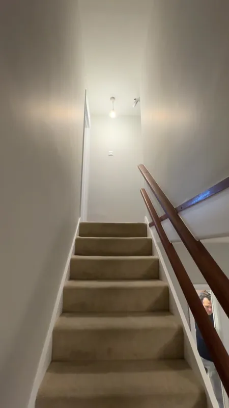 The stairwell: bare plaster, mist coated, then painted — after