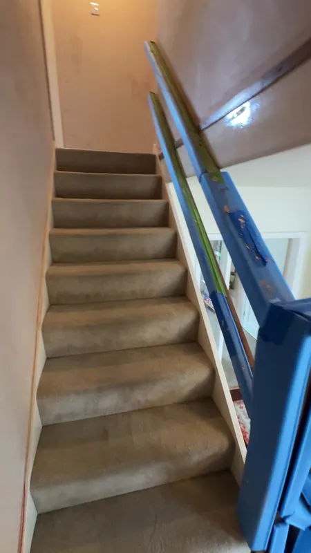 The stairwell when we arrived: bare new plaster