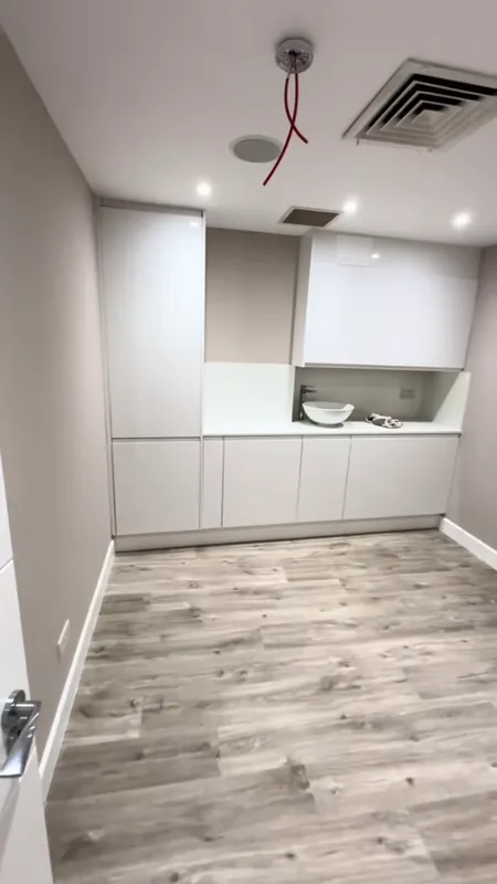 Basement: the old units stripped out, then the finished room — after
